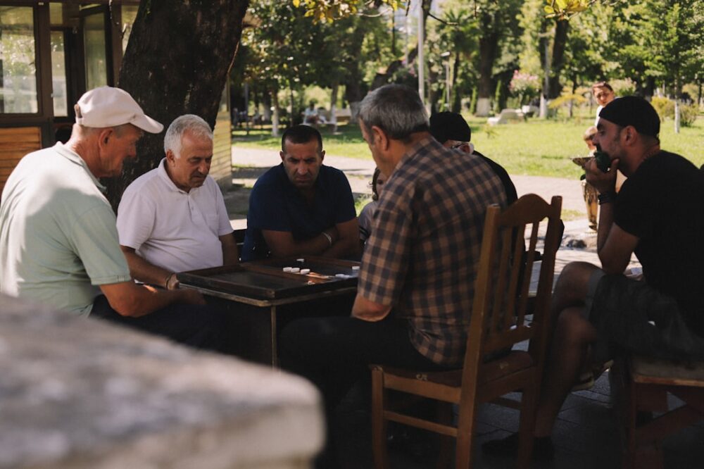 A group of men sitting around a wooden table