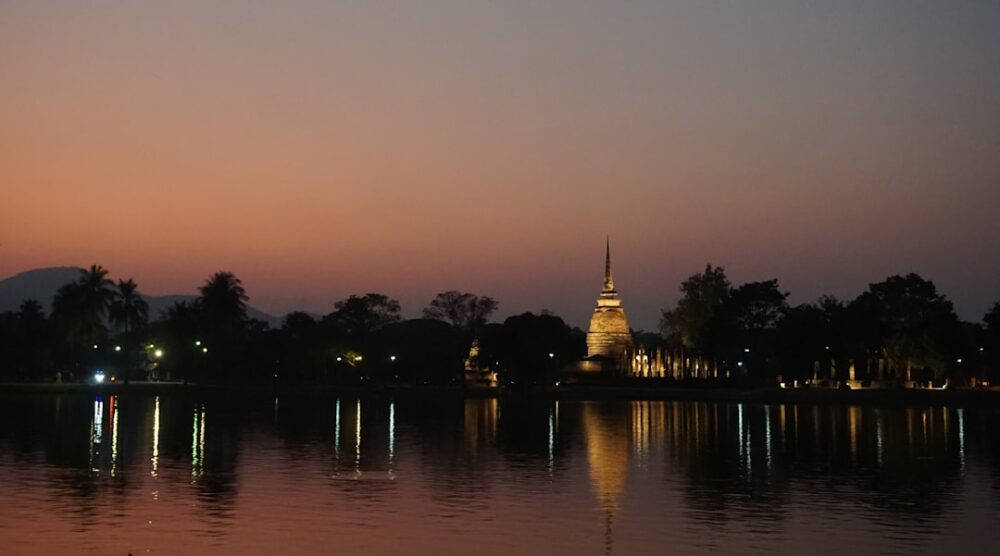 thailand temple sunset traveler reflection