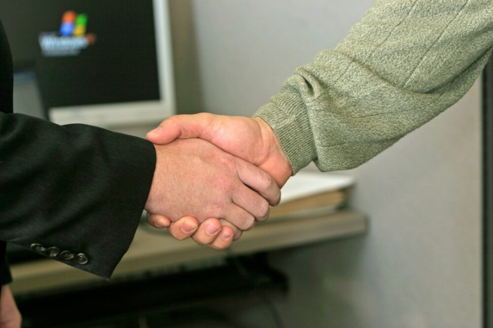 partnership handshake online learning laptop